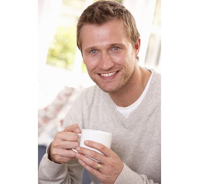 Guy drinking SOHO Morning Roast Coffee