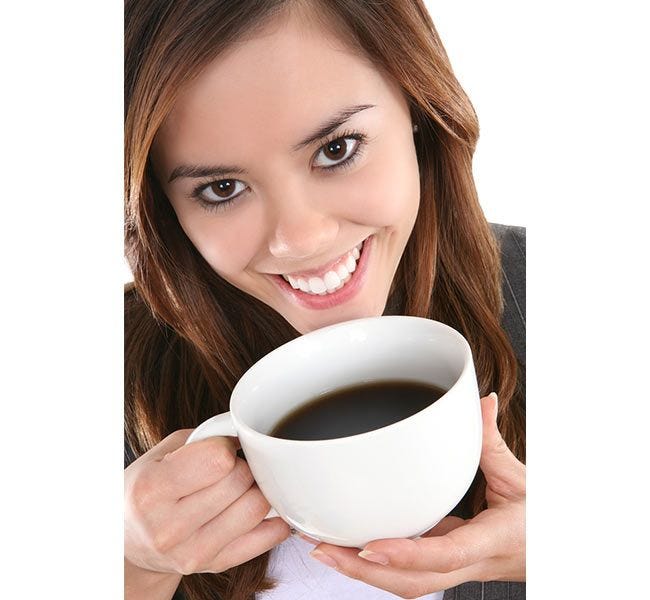 Woman drinking a cup of Midtown Decaf Chock full o'Nuts Coffee